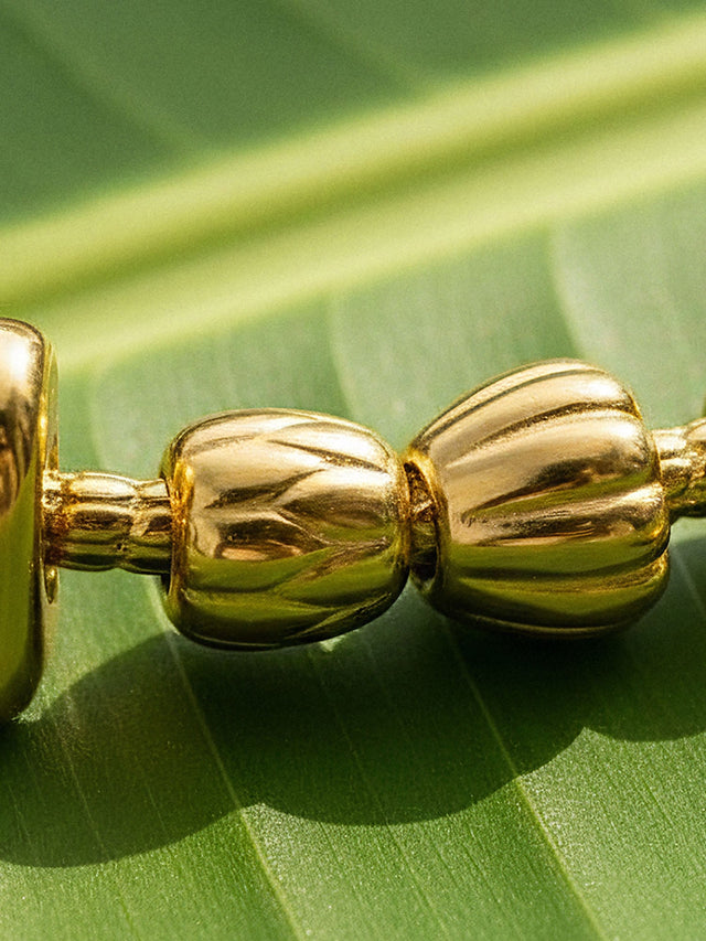 Lei Charm bangle with two stopper charms